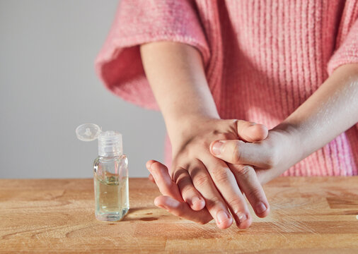 Hand cleansing with a hand sanitizer gel with alcohol 70 percent. A small bottle for rubbing hands. Protection against viruses and bacteria. Concept. Covid-19 or Coronavirus.