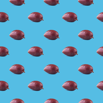 Colorful olives fruit pattern on a blue background, side view.