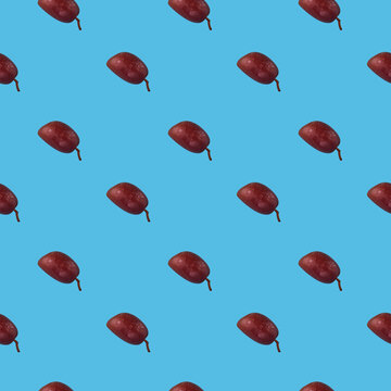 Colorful olives fruit pattern on a blue background, top view.