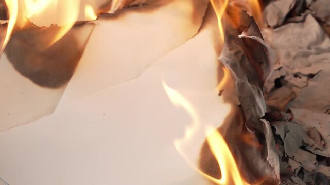 paper burning with bright yellow flames