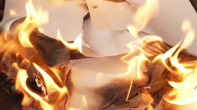 paper burning with bright yellow flames
