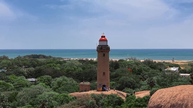 Lighthouse above ancient rock monuments along the Mahabalipuram shore