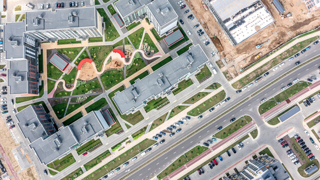 aerial top view of residential buildings complex with playground in courtyard.