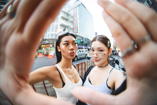 Portrait of authentic Gen Z asian woman identity self street fashion multicultural with accessories standing at outdoor