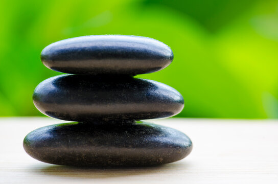 Stacked black zen stones representing harmony and relaxation, with customizable space for text.