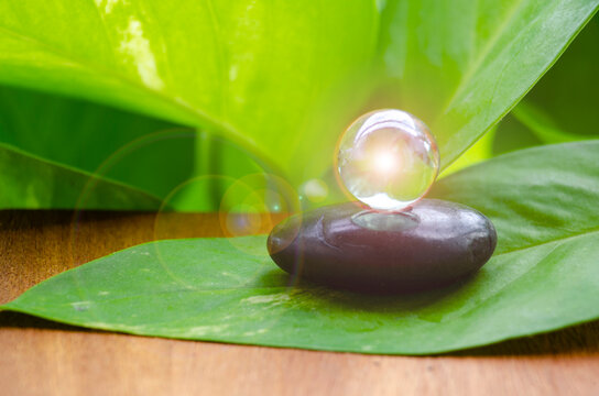 Shining marble on zen stone in nature representing serenity and peaceful connection, with customizable space for text.