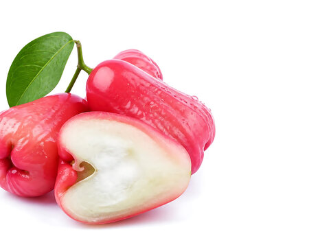 Close-up macro view of fresh rose apples clustered naturally with one sliced fruit in front, crisp juicy texture, subtle water droplets, vibrant natural colors, high sharpness