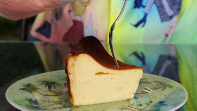 Close up of a fork digging into a slice of Basque burnt cheesecake as a sweet self-reward
