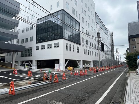 Nearly completed glass building against the sky, Ota, Gunma, Japan