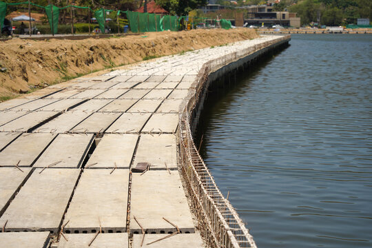 Building process city levee. Exposed foundation rebar grid at site, standing formwork and concrete footings