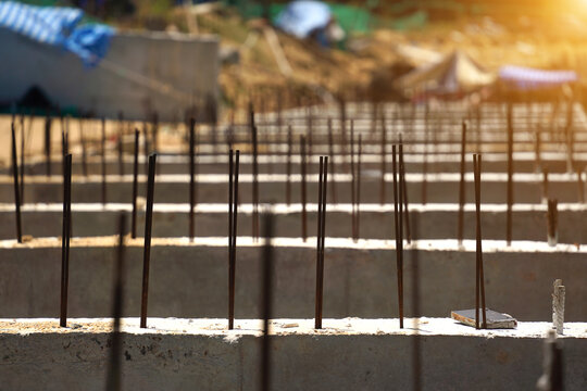 Building process city levee. Exposed foundation rebar grid at site, standing formwork and concrete footings