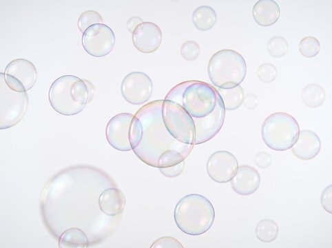 白い背景に舞い上がる透明感あふれる幻想的なシャボン玉