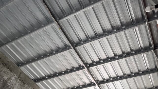 Modern industrial corrugated metal ceiling texture inside a house or building interior structure