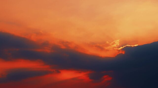 Cinematic Jacob's rays shooting from behind a storm cloud during a breathtaking sunset