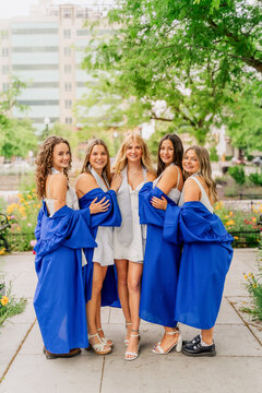 Group of friends celebrate graduation day outside