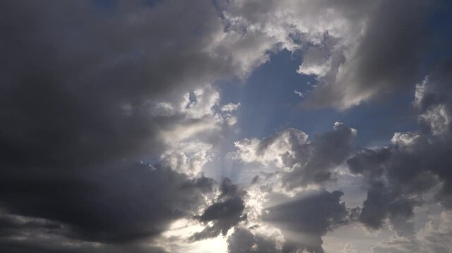 Dynamic sky clouds moving with sun rays passing through the clouds. Timelapse video sky only background