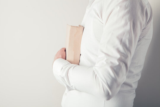 Close up man hands.Young man opening and reading a book