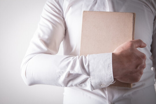 Close up man hands.Young man opening and reading a book