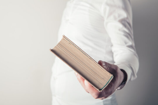 Close up man hands.Young man opening and reading a book