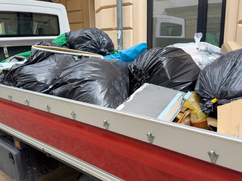 Van Loaded with Waste Bags and Household Refuse After Apartment Clearance &ndash; Disposal and Cleanout Service