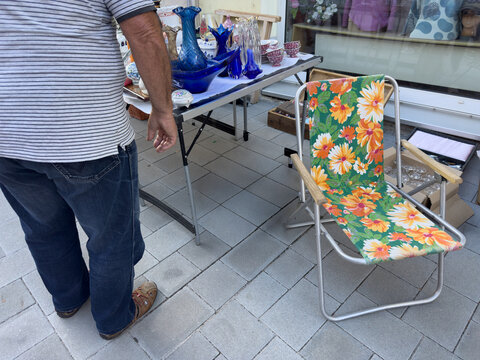 Older Man Browsing Antiques at a City Flea Market