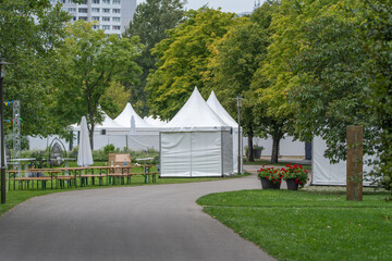 Park Pathway Lined With Event Tents and Red Geraniums © Jakob
