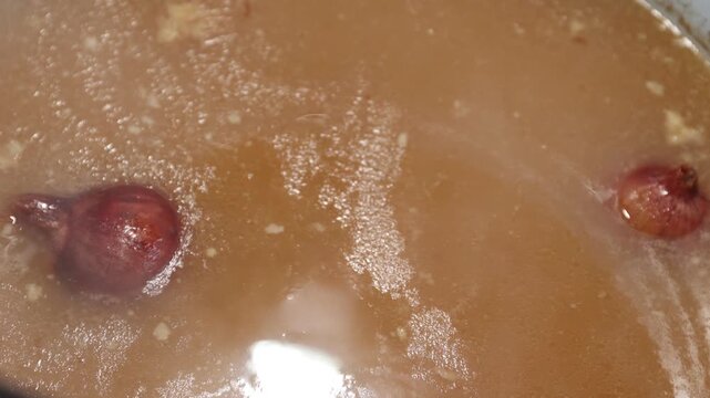 Slow-simmered bone broth in a pot: long-cooking, rich homemade stock