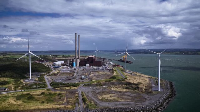 Industrial energy facility, electricity infrastructure, port area, and renewable energy installations, transitioning from coal-fired plant into green energy hub, Moneypoint power station, Ireland.