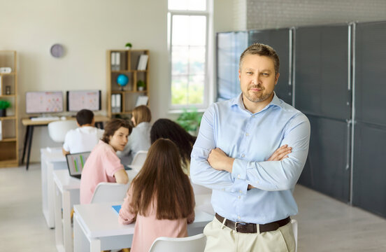 Teacher with students in classroom during lesson. Professor leads a school class with confidence and supports active learning. Clear concept education leadership and classroom management.