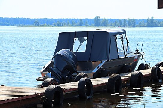  A Yamaha-powered boat at a wooden pier on the Kama River.