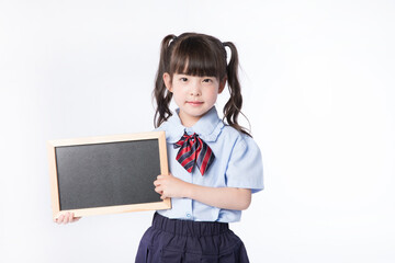 Young schoolgirl holding blank blackboard in school uniform © LuuDieu