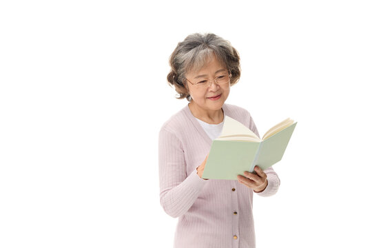Senior Asian woman reading book on white background