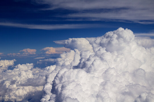 Aerial View Above Fluffy Cumulus Clouds Under Deep Blue Sky