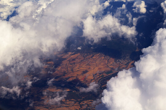 Aerial View Above Fluffy Cumulus Clouds Under Deep Blue Sky