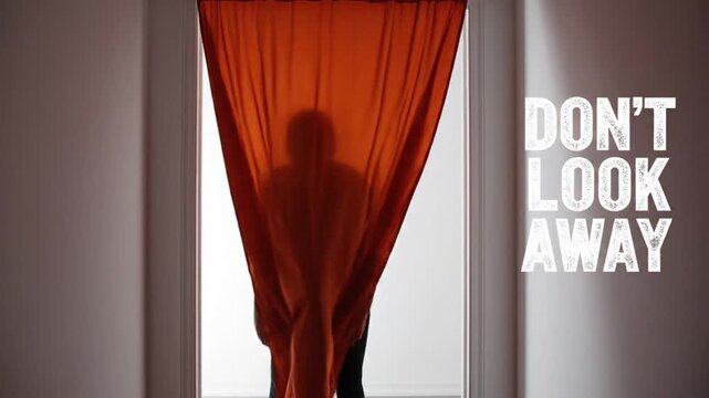 Silhouette of person standing behind orange fabric curtains revealing cinematic suspense motion footage for mystery themed psychological thriller film project
