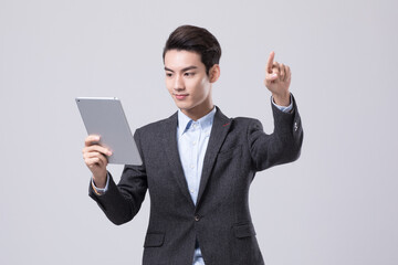 Young businessman using tablet and touching virtual interface © ThaiDieu