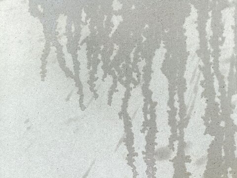 grunge wall background, Old cement wall texture, wet cement wall, creating a pattern, light and dark grey, flow of water from high to low, image of water distribution from splashing.
