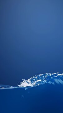 Close Up of a Small Blue Water Wave Rippling Against a Solid Blue Background