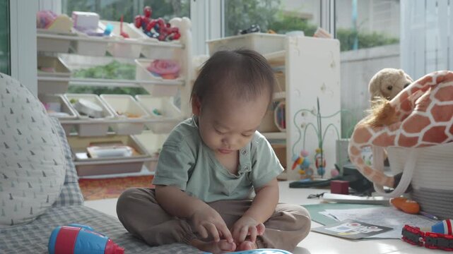 A young child engages in imaginative play within a well-lit room filled with toys and educational materials. The scene captures the essence of childhood creativity and the importance of a stimulating 