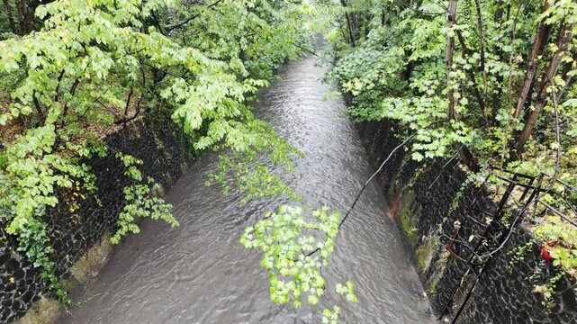 River Rea in Flood, Birmingham &mdash; Rain-Swollen River Flowing Through Calthorpe Park Culvert.
The River Rea swollen with heavy rainwater as it flows through a stone-lined culvert by Calthorpe Park.
