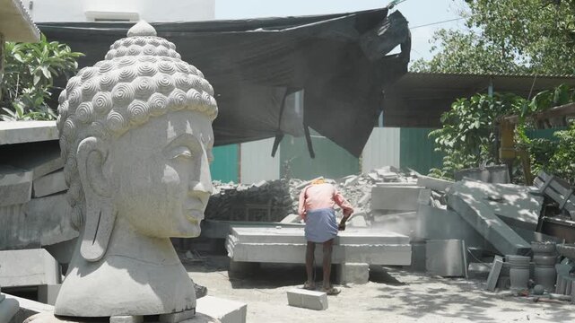 Stone sculpture workshop India while buddha statue in foreground