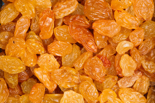Golden raisins filling the frame in a close up food background