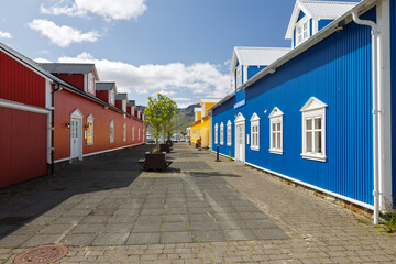 Naklejka premium Colorful traditional wooden houses on paved street in town
