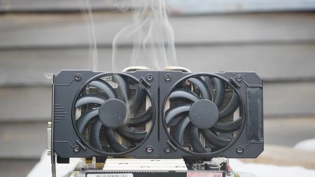 Faulty burned-out video card with two coolers from the computer. GPU card. IT hardware.