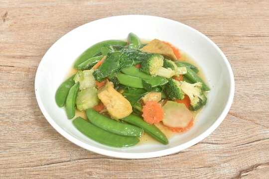 stir fried mixed vegetable with slice tofu in soy sauce vegetarian food on dish