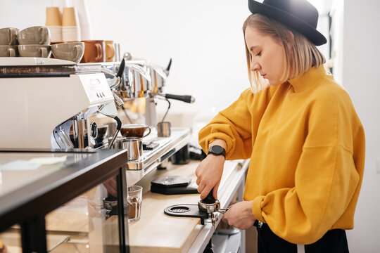 Barista making coffee with coffee machine