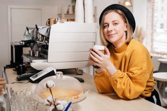 Female barista at her work place at the counter