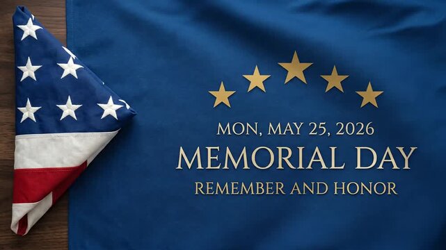 Memorial Day holiday text on blue cloth next to folded American flag