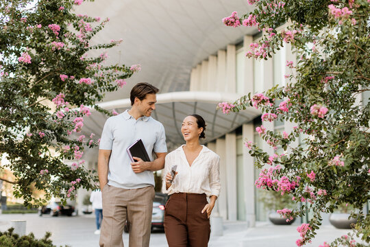 Couple enjoys a cheerful stroll surrounded by blooming flowers in a city