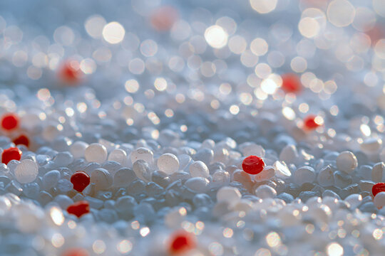 Macro Close-up of Countless Translucent White and Clear Plastic Granules with Vibrant Red Pellets, Creating an Abstract Textured Background with Bokeh Lights, Highlighting Industrial